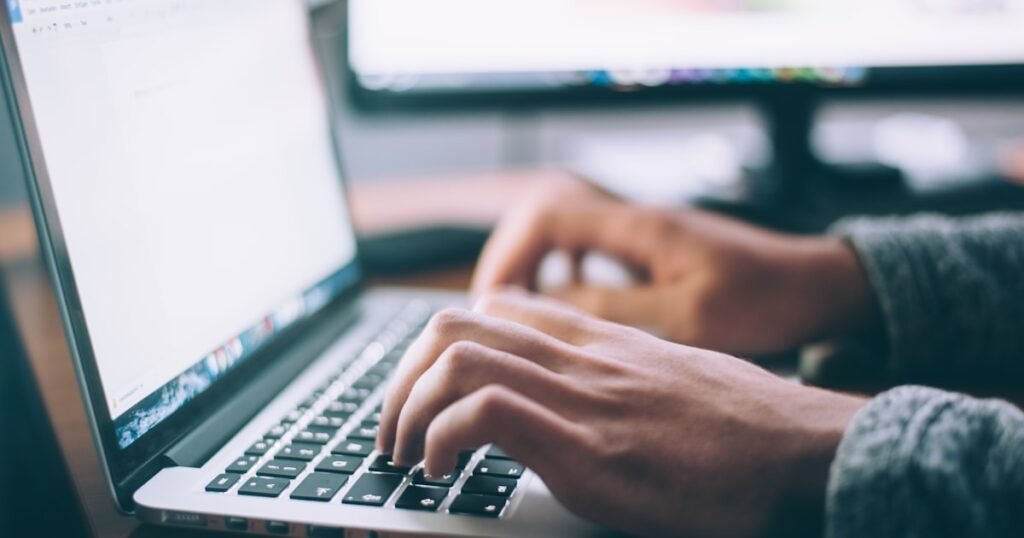 Cara Membuat Press Release - person writing laptop